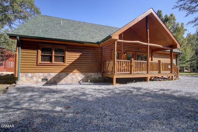 back of property featuring a shingled roof and crawl space