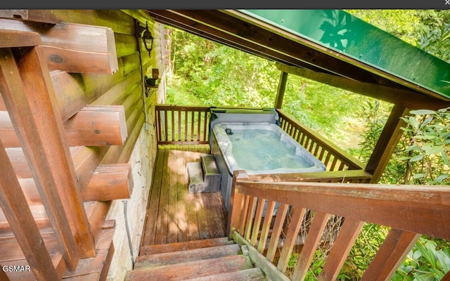 wooden deck with a hot tub