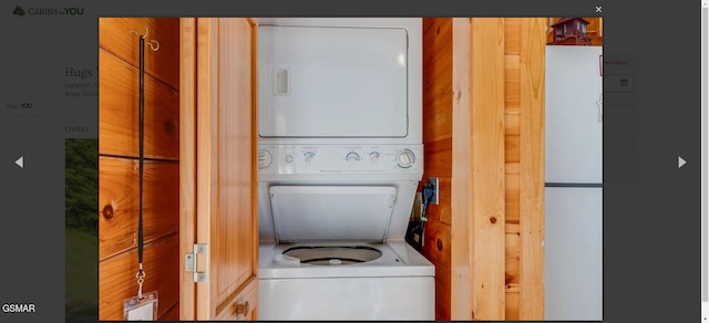 washroom featuring stacked washer and dryer