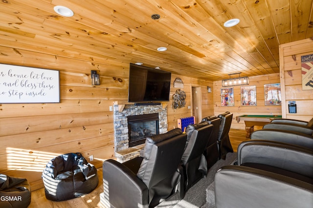 living area with wooden ceiling, billiards, wood finished floors, and a stone fireplace