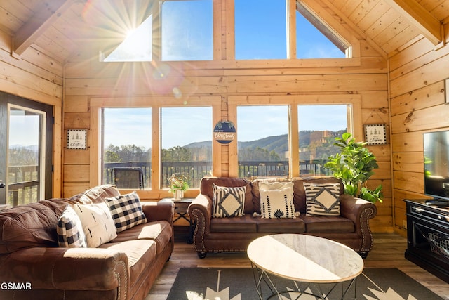 living room featuring vaulted ceiling with beams, wood walls, wooden ceiling, and wood finished floors