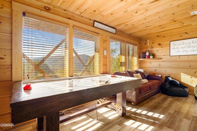 recreation room with wood ceiling, wood walls, a sauna, and wood finished floors