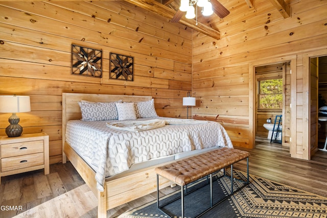 bedroom with wood ceiling, beamed ceiling, wooden walls, and wood finished floors