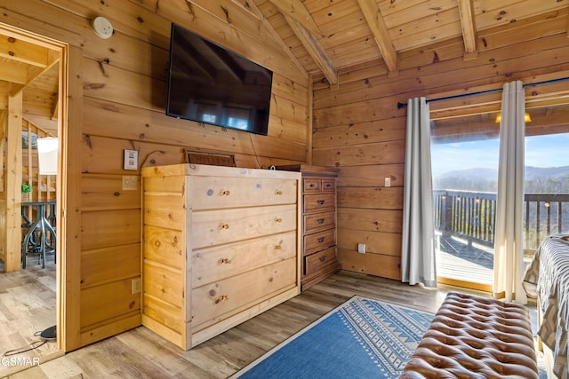 unfurnished bedroom featuring light wood-style floors, lofted ceiling with beams, wood ceiling, access to exterior, and wood walls