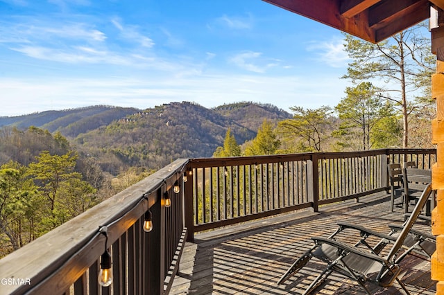 deck with a mountain view and a wooded view