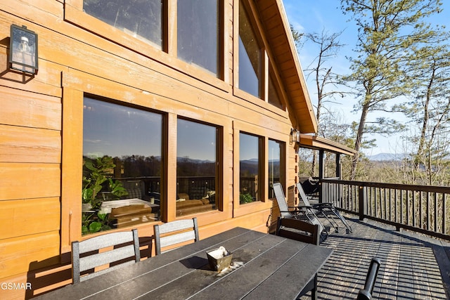 wooden terrace with outdoor dining area