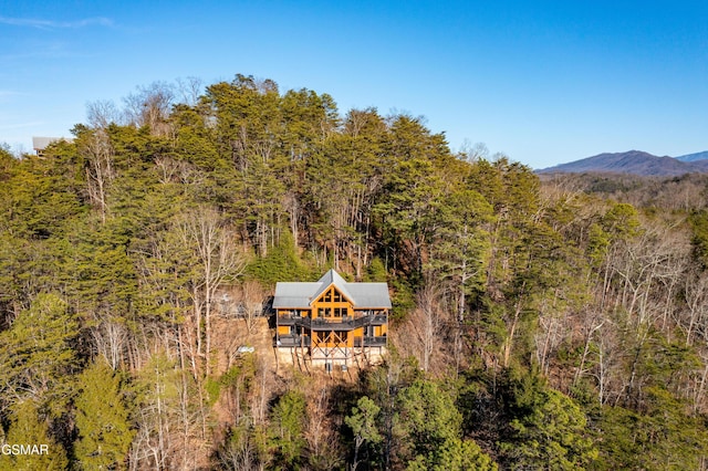 aerial view featuring a mountain view and a view of trees