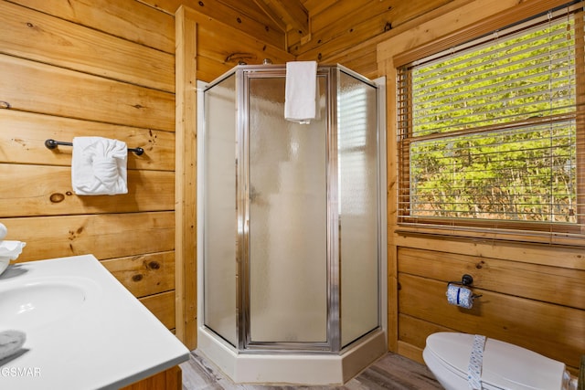 full bath with toilet, a stall shower, and wooden walls