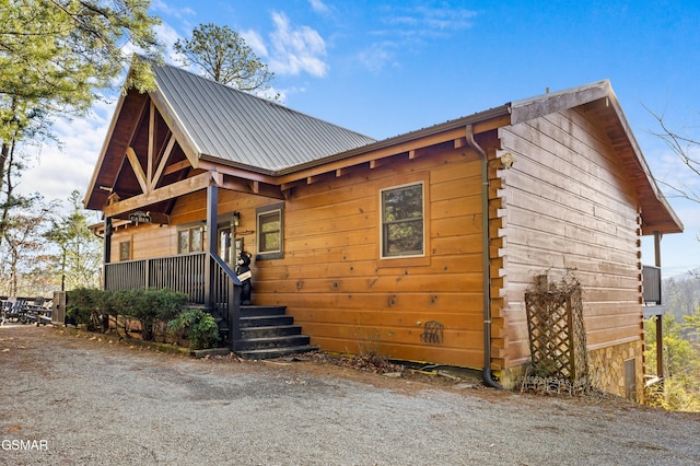 rustic home with a porch and metal roof