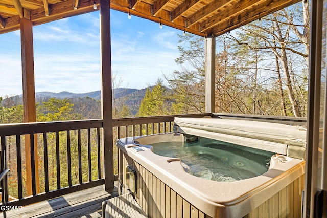 wooden terrace with a mountain view and a hot tub