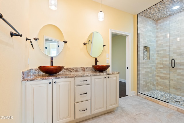 bathroom featuring vanity and a shower with shower door