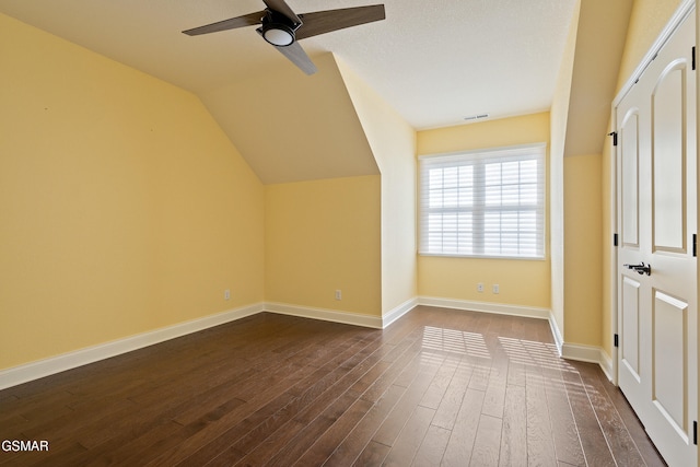 additional living space with dark hardwood / wood-style floors, ceiling fan, and lofted ceiling