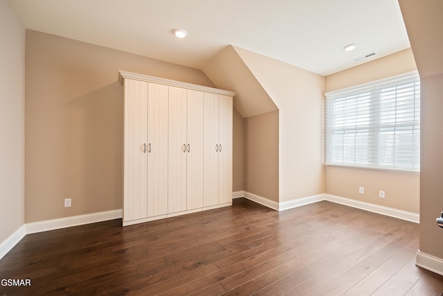 unfurnished bedroom with dark hardwood / wood-style floors and a closet