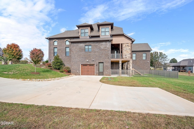 view of front of property with a front yard, a balcony, and a garage