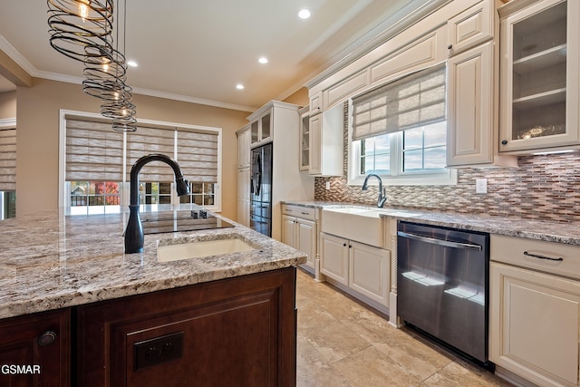 kitchen featuring refrigerator, light stone counters, sink, pendant lighting, and dishwasher