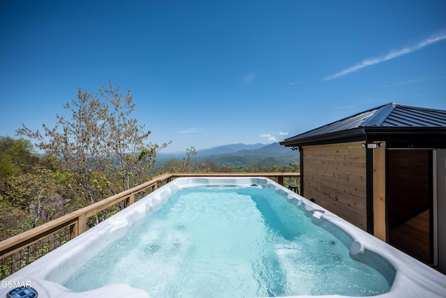 view of swimming pool with a deck with mountain view