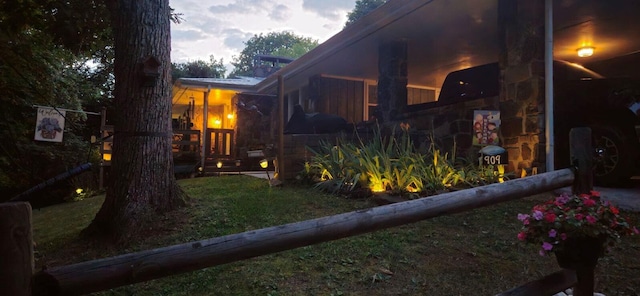 property exterior at dusk featuring a yard