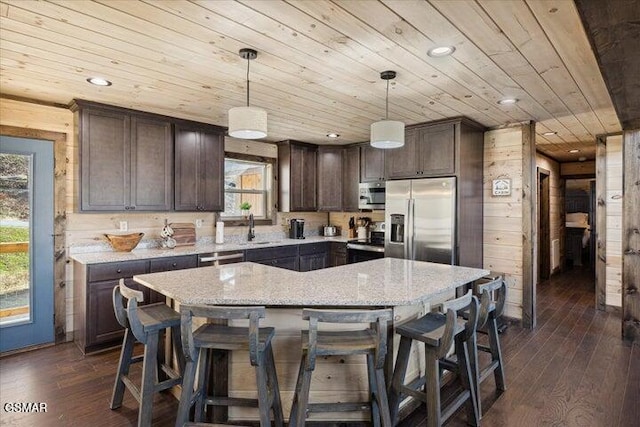 kitchen with wood ceiling, dark brown cabinetry, dark wood finished floors, and stainless steel appliances