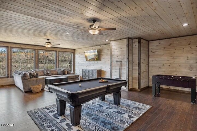 recreation room with wooden walls, wooden ceiling, and ceiling fan
