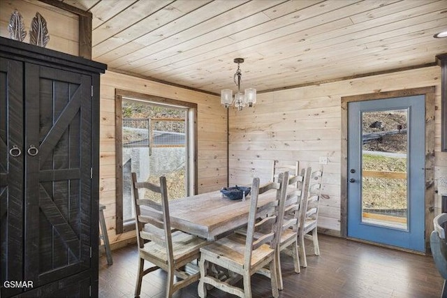 dining space with wood walls, wood ceiling, an inviting chandelier, and wood finished floors