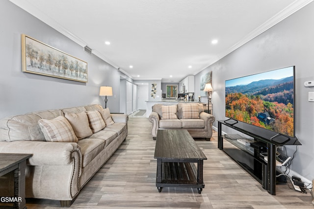 living room featuring ornamental molding and light wood-type flooring