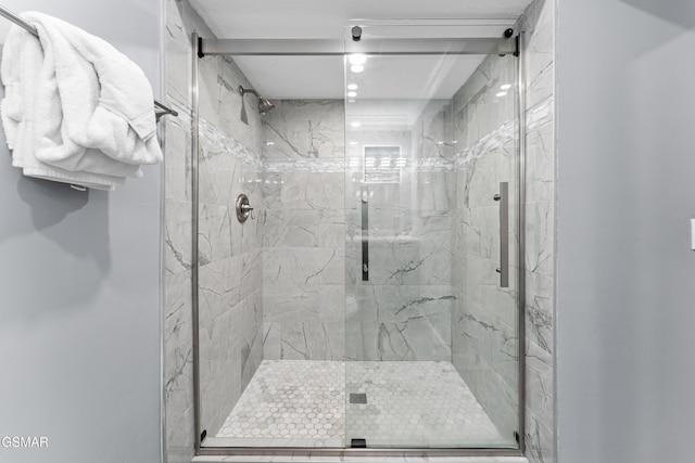 bathroom with a shower with door