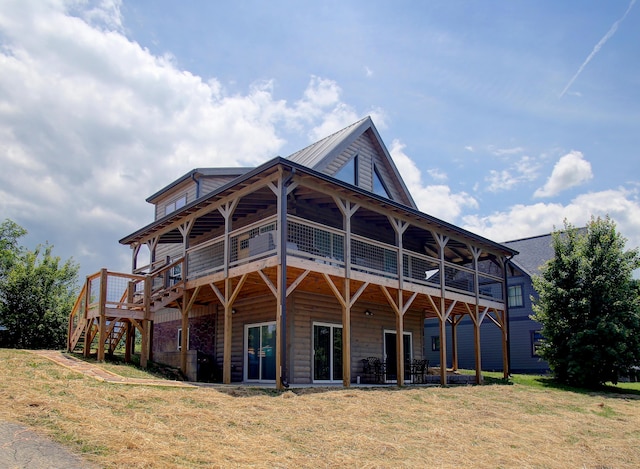 back of house featuring a deck and a yard