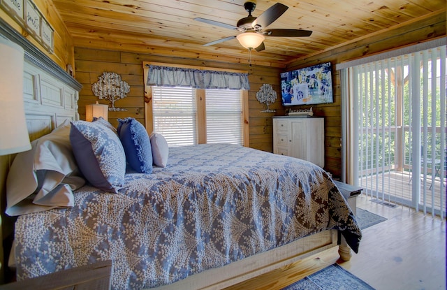 bedroom featuring access to outside, multiple windows, ceiling fan, and wood ceiling