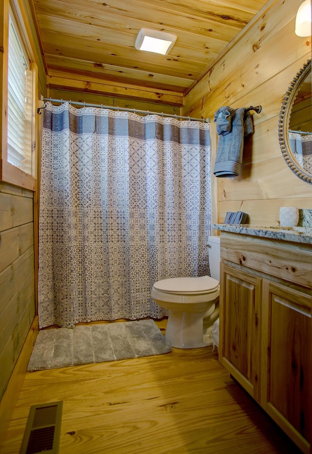 bathroom with wood ceiling, vanity, hardwood / wood-style flooring, toilet, and wood walls