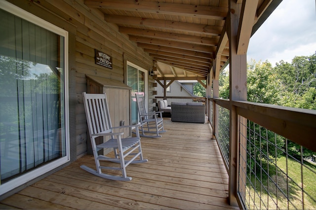 wooden terrace with an outdoor hangout area