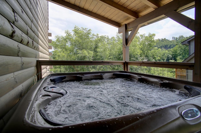 wooden deck with a hot tub