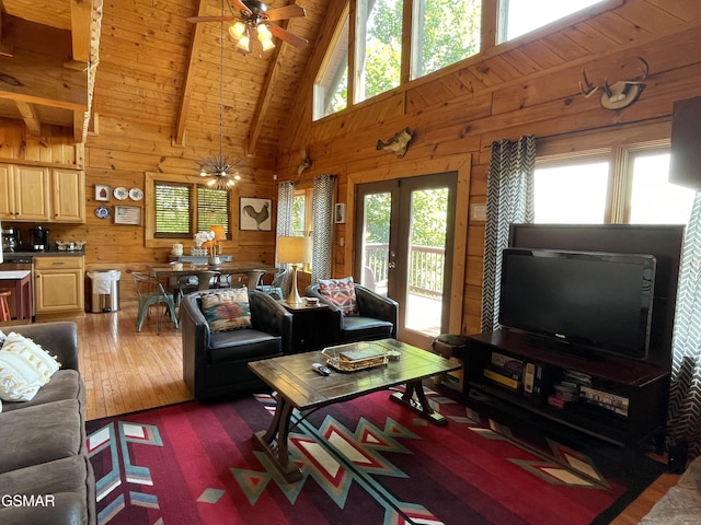 910 Laurel Lick Rd, Pigeon Forge, TN 37863 - living area with healthy amount of natural light, a ceiling fan, wood walls, dark wood-style floors, and high vaulted ceiling