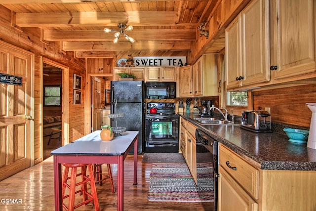 910 Laurel Lick Rd, Pigeon Forge, TN 37863 - kitchen featuring black appliances, wood ceiling with exposed beams, a sink, wooden walls, and wood finished floors