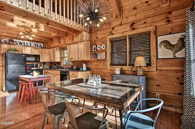 910 Laurel Lick Rd, Pigeon Forge, TN 37863 - dining room featuring a chandelier, wooden walls, and light wood finished floors
