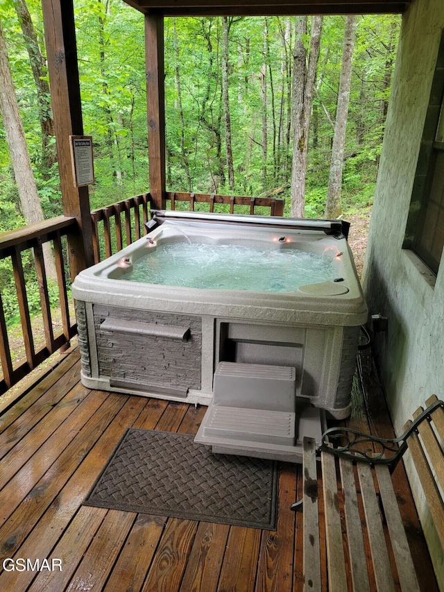 wooden terrace featuring a hot tub