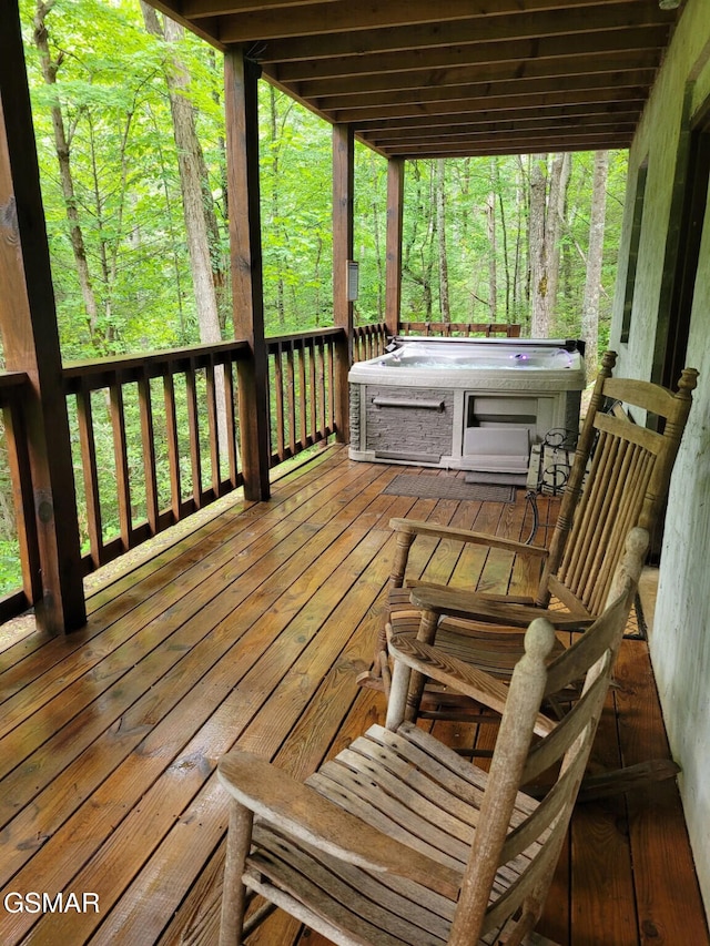 wooden deck with a hot tub