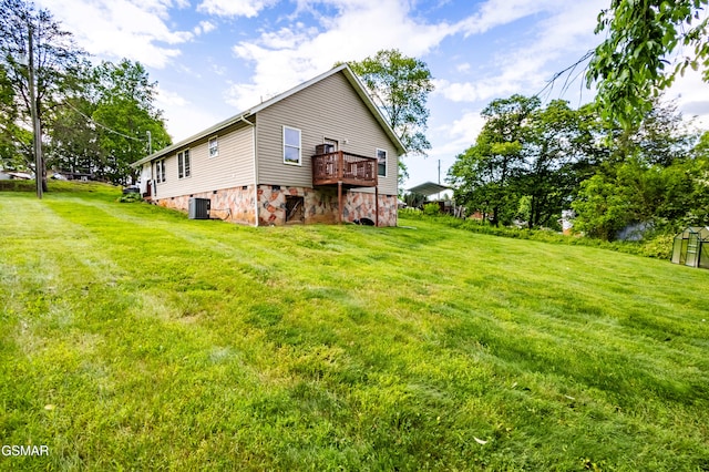 back of house with central AC, a lawn, and crawl space
