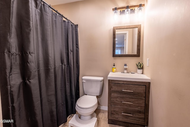 bathroom with toilet, vanity, tile patterned floors, and curtained shower