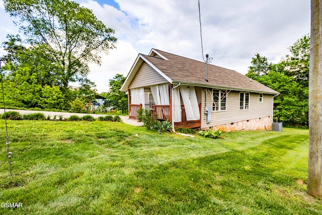 back of house with crawl space, a yard, central AC unit, and a shingled roof