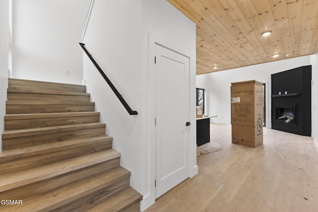 staircase featuring hardwood / wood-style floors and wood ceiling