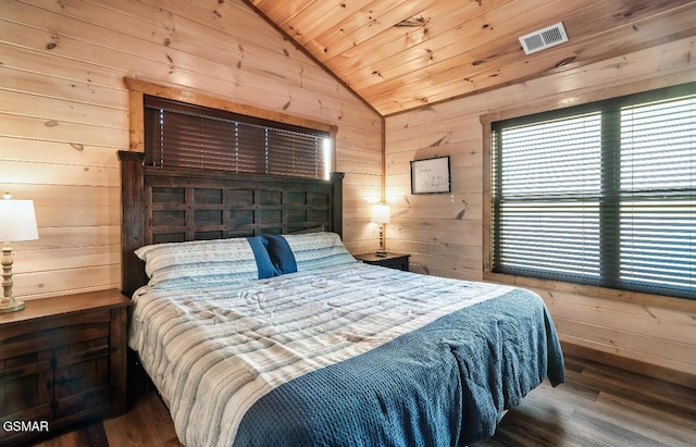 bedroom featuring wooden ceiling, wooden walls, dark hardwood / wood-style floors, and vaulted ceiling