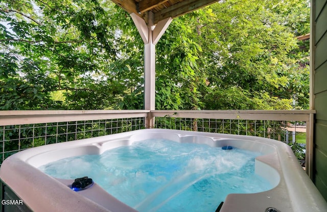 view of pool with a hot tub