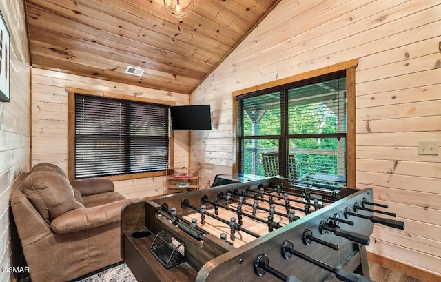 game room with wood walls, lofted ceiling, and wooden ceiling