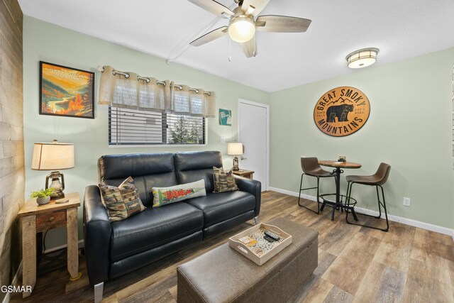 living room featuring ceiling fan and wood-type flooring