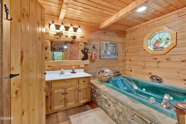 bathroom featuring a tub, beamed ceiling, hardwood / wood-style floors, vanity, and wood ceiling