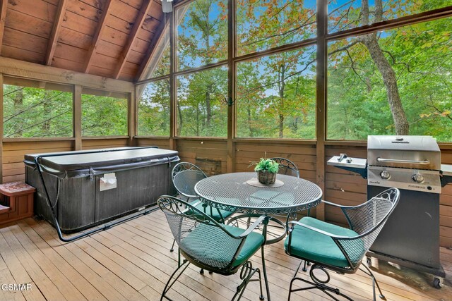 sunroom / solarium featuring lofted ceiling with beams, plenty of natural light, wooden ceiling, and a hot tub