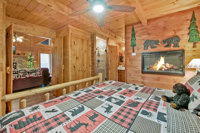 bedroom with beamed ceiling, wooden ceiling, and wood walls