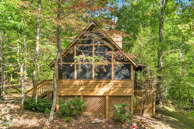 view of outbuilding with a sunroom