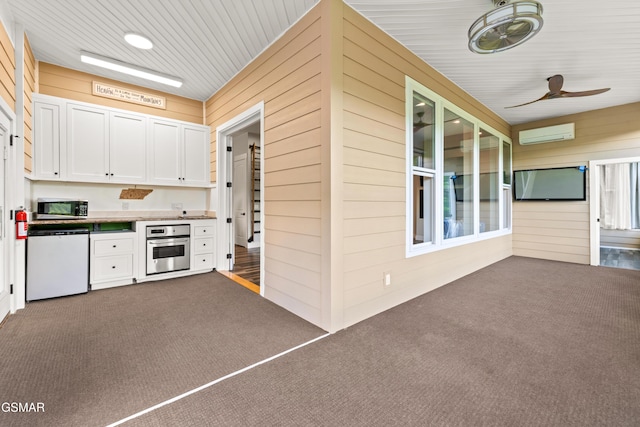 3955 Denton Ct, Sevierville, TN 37862 - view of patio with an AC wall unit, a ceiling fan, and exterior kitchen