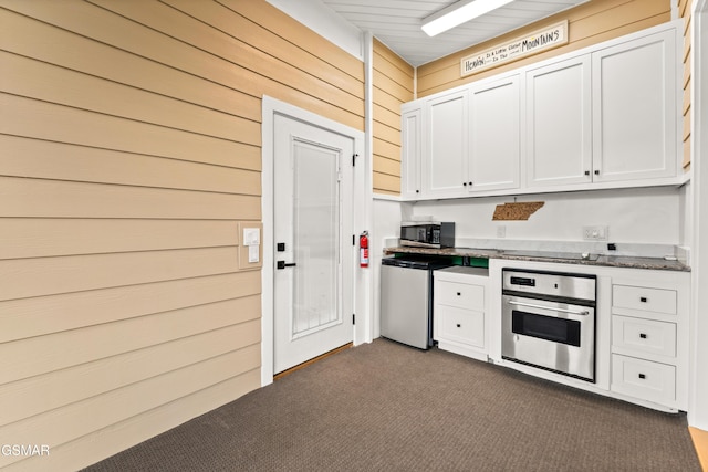 3955 Denton Ct, Sevierville, TN 37862 - kitchen with appliances with stainless steel finishes, dark carpet, and white cabinets